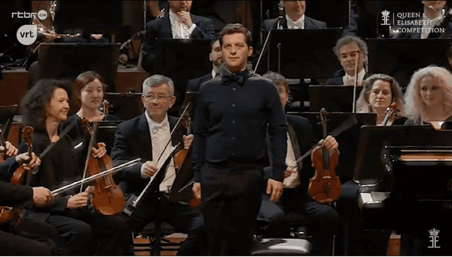 Henry standing in front of an orchestra